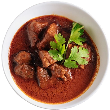 A spicy Indian mutton curry or Rogan Josh, garnished with fresh cilantro. It is the best Indian food